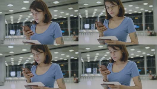女游客在机场用电话办理登机手续高清在线视频素材下载
