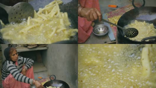 印度妇女在土坯炉上烹饪传统小吃。高清在线视频素材下载