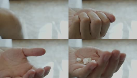 一名亚洲男子正在服用手边的白色药物。高清在线视频素材下载
