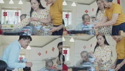 家庭成员在中国新年聚餐时互相服务的慢蛾镜头高清在线视频素材下载