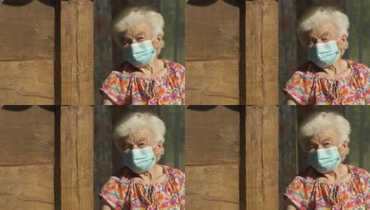 真实人物老年妇女戴口罩以避免传染病。看着相机微笑高清在线视频素材下载