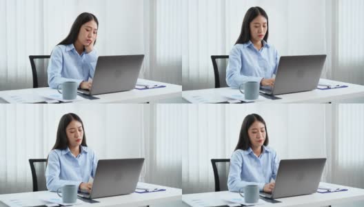 一段女商人在办公室用笔记本电脑工作时看起来很焦虑的4k视频高清在线视频素材下载