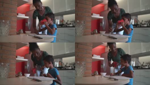 在家上学的时候，母亲在厨房给儿子喝的东西高清在线视频素材下载