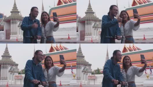 潮男美女在旅游著名景点(卧佛寺)时用手机搜索信息;曼谷泰国高清在线视频素材下载