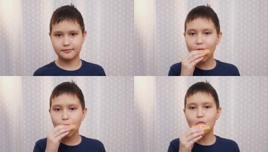 一个男孩咬饼干的特写高清在线视频素材下载