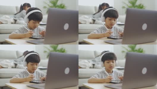 亚洲男孩在笔记本电脑上学习在线课程高清在线视频素材下载