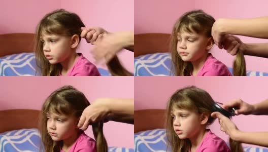 母亲为她的长发姑娘梳头，并把她们编成辫子高清在线视频素材下载