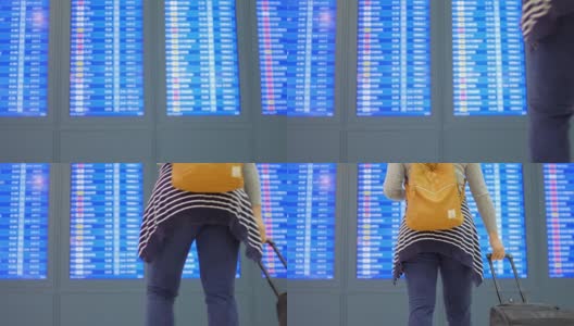 女乘客在离港机场办理登机手续前用手机检查她的航班高清在线视频素材下载