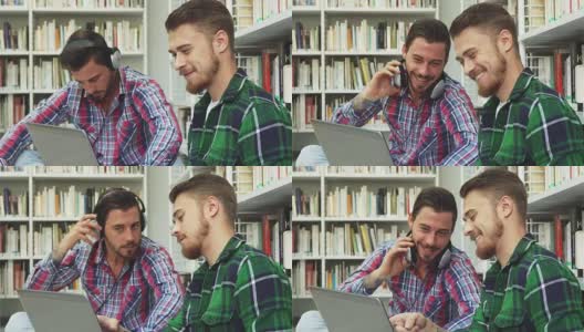 两个帅哥在图书馆度过他们的空闲时间高清在线视频素材下载