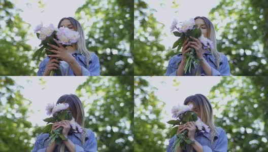 年轻貌美的女子欣赏着牡丹花的花束高清在线视频素材下载