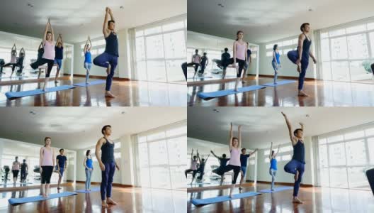 一群在健身馆练习瑜伽的年轻人，健身、运动和健康的生活理念高清在线视频素材下载