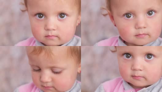 一个可爱的悲伤的婴儿与大眼睛的特写肖像。高清在线视频素材下载
