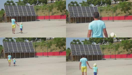 父亲给儿子看太阳能电池板高清在线视频素材下载