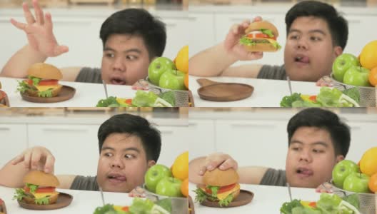 特写:泰国超重男子更喜欢不健康的食物，比如汉堡包，而不是沙拉或水果高清在线视频素材下载