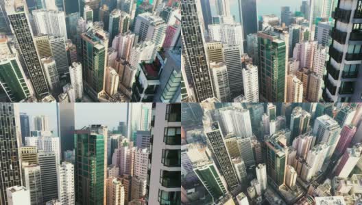 香港中环无人机鸟瞰图。现代化的摩天大楼和大都市的高楼大厦，城市交通系统。摄像机从上到下移动。高清在线视频素材下载