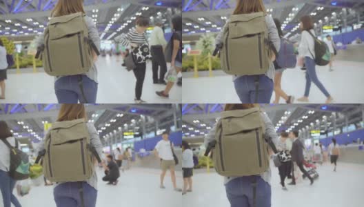 慢镜头-年轻的亚洲背包女走在国际机场。高清在线视频素材下载