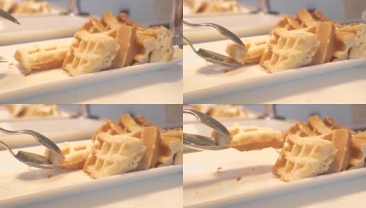 传统的比利时华夫饼躺在白色盘子上的自助餐在酒店餐厅。甜烤华夫饼作为早餐。甜点食品的概念。饮食和营养高清在线视频素材下载