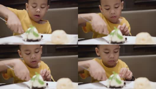 快乐的小男孩在吃甜点。高清在线视频素材下载