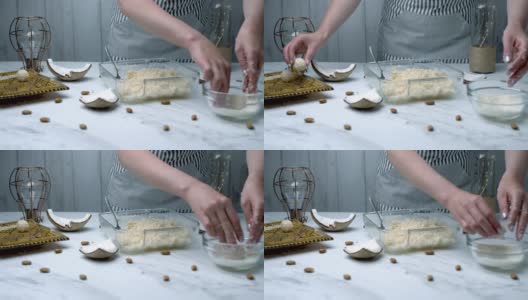 女人的手正在准备椰子巧克力碗。将干燥的椰子、枫糖浆和椰子黄油搅拌在一起，揉搓成碗状。手工巧克力的概念。高清在线视频素材下载
