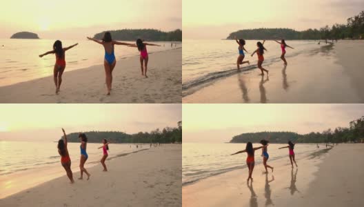 一群亚洲女性朋友一起在热带海滩玩海水高清在线视频素材下载
