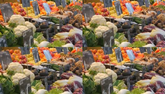 大城市蔬菜市场。种类繁多的蔬菜和水果可供选择。健康的新鲜有机素食食品在柜台上。德语价格标签高清在线视频素材下载