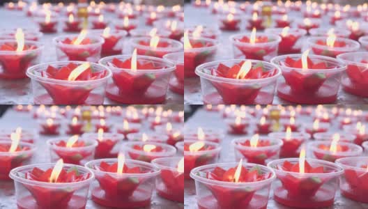 桌上放着红莲花蜡烛。祈祷好运。中国新年。中国的寺庙。高清在线视频素材下载