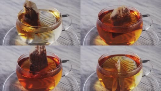 将一袋红茶倒入装有沸水的玻璃杯中高清在线视频素材下载