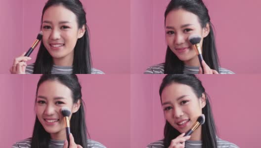女人化妆。一位年轻的亚洲女子用化妆刷在脸上刷腮红。化妆品的概念高清在线视频素材下载