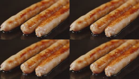 香肠在煎锅里用热油煎。高清在线视频素材下载