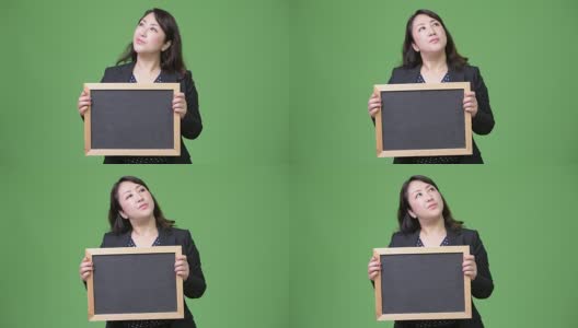 成熟美丽的亚洲女商人一边展示黑板一边思考高清在线视频素材下载