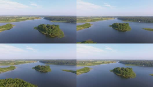 鸟瞰图绿色岛屿和云在夏天阳光明媚的早晨。波兰的马苏里安湖区。从上面看世界奇观。高清在线视频素材下载