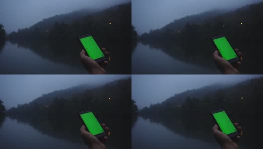 男子在河边使用手机绿屏高清在线视频素材下载