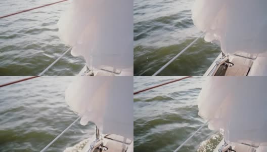 近距离观看帆板板。白色的裙子挂在游艇上。船全速前进高清在线视频素材下载