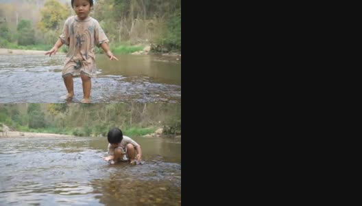 小男孩在小溪里玩水。高清在线视频素材下载