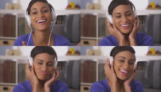 漂亮的黑人女人戴着耳机听音乐高清在线视频素材下载