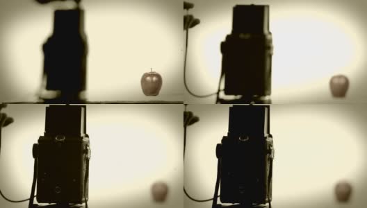 用老式的50年代长曝光相机拍摄苹果的静物。高清在线视频素材下载