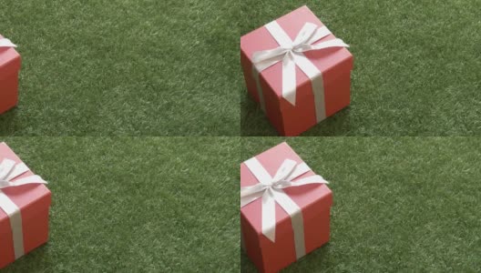 绿草上带蝴蝶结的礼盒。高清在线视频素材下载