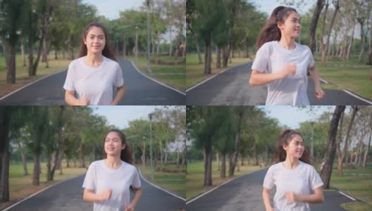 亚洲女运动员的肖像是在绿色公园的道路上慢跑，带着傍晚的光和快乐的情绪微笑高清在线视频素材下载