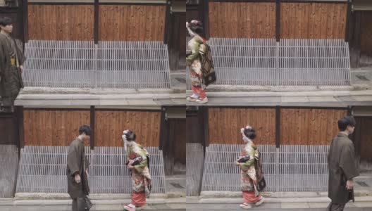 舞妓(正在训练的艺妓)和一个男人在日本老街道鞠躬袴高清在线视频素材下载