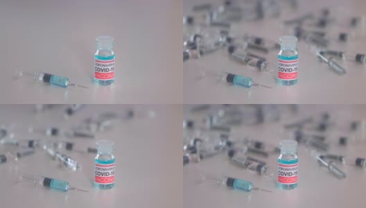 医生病毒学护士带着疫苗瓶、注射器、注射剂量、疫苗安瓿、Covid-19冠状病毒脱落物在医学实验室高清在线视频素材下载