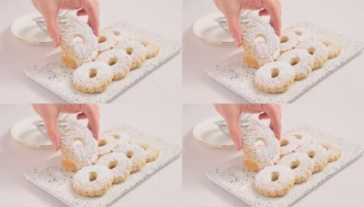 Canestrelli，传统利古里亚洋甘菊形状的糖粉饼干。来自意大利南部的节日烘焙食品，手里拿着卷饼意面。水平的视频高清在线视频素材下载