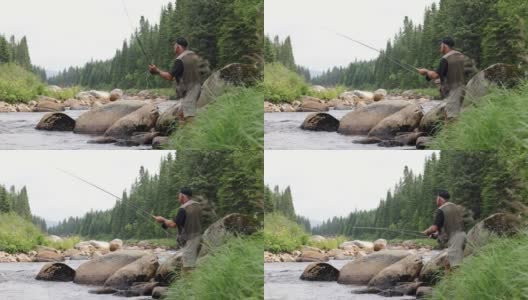 一位老人在魁北克的河里用假蝇钓鱼高清在线视频素材下载