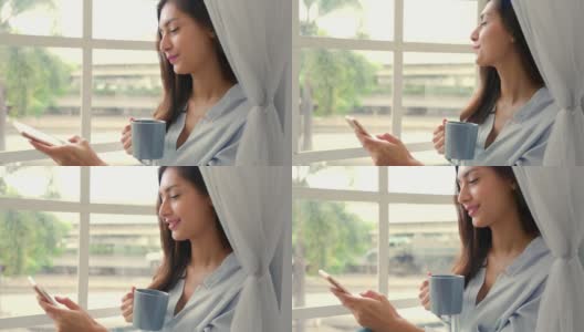 一名年轻的白人女子坐在沙发上，享受着早上的第一杯咖啡。高清在线视频素材下载