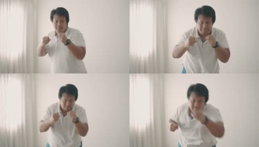 亚洲男子在家里进行拳击锻炼减肥高清在线视频素材下载