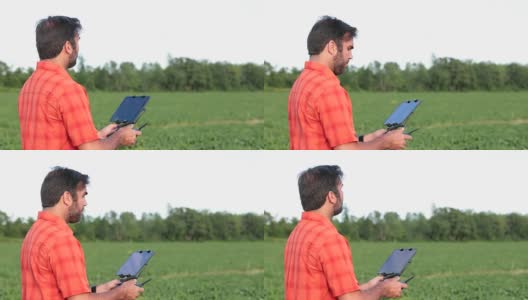 4K视频农民飞行员在日落时使用无人机控制器高清在线视频素材下载