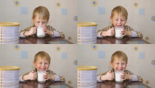 有趣的孩子高兴地喝奶粉高清在线视频素材下载