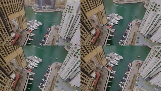 从空中俯瞰摩天大楼、水上和游艇之间的长廊。这条步行街散步高清在线视频素材下载