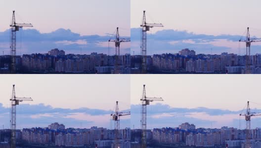 起重机在日落时分工作。建筑工地以城市建筑为背景。间隔拍摄4 k。高清在线视频素材下载