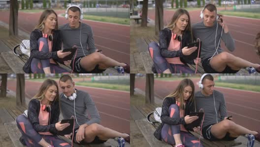 一对运动夫妇在跑道旁欣赏音乐高清在线视频素材下载