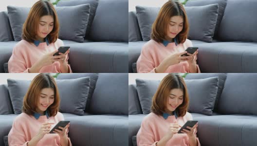 年轻美丽的亚洲女人用智能手机与幸福坐在客厅，人们在电话，生活方式高清在线视频素材下载